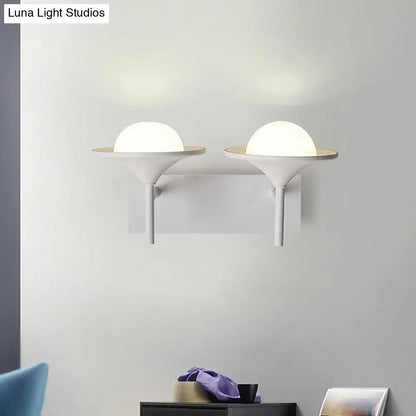 Modern white metallic flared wall sconce with sleek minimalist design and frosted glass domes for bedroom LED lighting