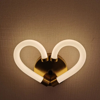 Gold-toned heart-shaped led wall lamp with two curved frosted glass arms for modern minimalist bedroom decor