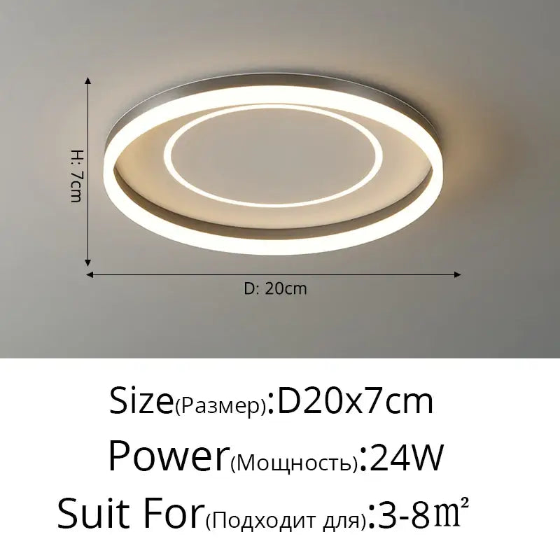 Modern white minimalist ceiling light strip with a silver metallic frame and two glowing LED rings for living room use