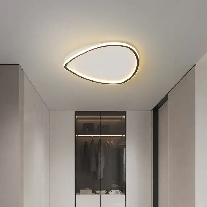 Modern white minimalist led ceiling light strip with a teardrop-shaped black frame and soft white illuminated surface