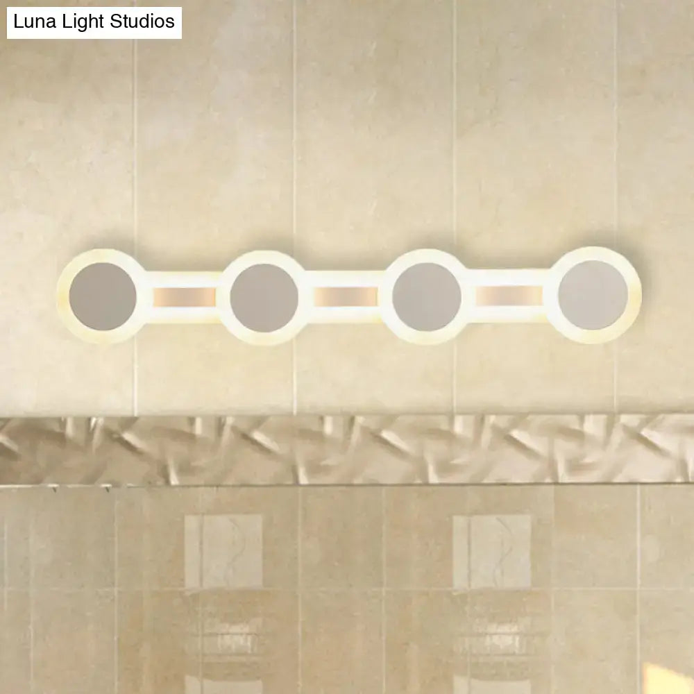 Modern white minimalist led vanity light with four circular bulbs on a sleek frame 110v-120v maximum bulb wattage