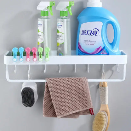 Modern white plastic corner shelf with towel bar holding a beige towel brush and scrubber for kitchen storage decorbites black corner