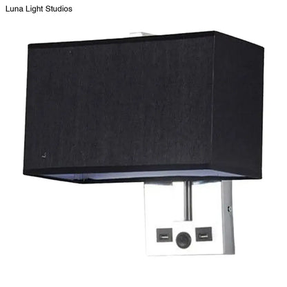 Black rectangular fabric lampshade mounted on a white metal base with two usb ports and a central power button.