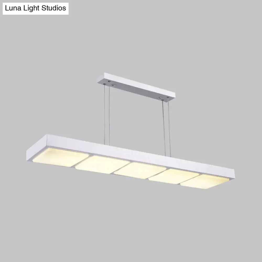 Modern white metal rectangular island lamp with four evenly spaced softly glowing panels for office use