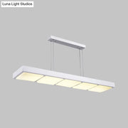 Modern white metal rectangular island lamp with four evenly spaced softly glowing panels for office use