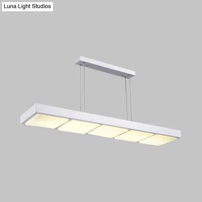 Modern white metal rectangular island lamp with four evenly spaced softly glowing panels for office use