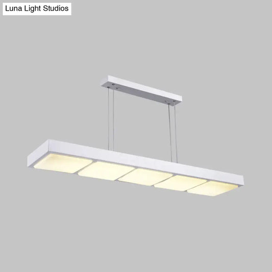 Modern white metal rectangular island lamp with four evenly spaced softly glowing panels for office use