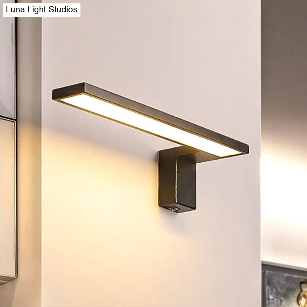 Modern black rectangular wall lamp with sleek minimalist design emitting warm white light for bedroom use