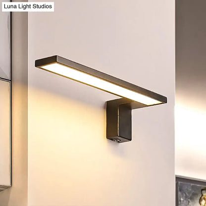 Modern black rectangular wall lamp with sleek minimalist design emitting warm white light for bedroom use