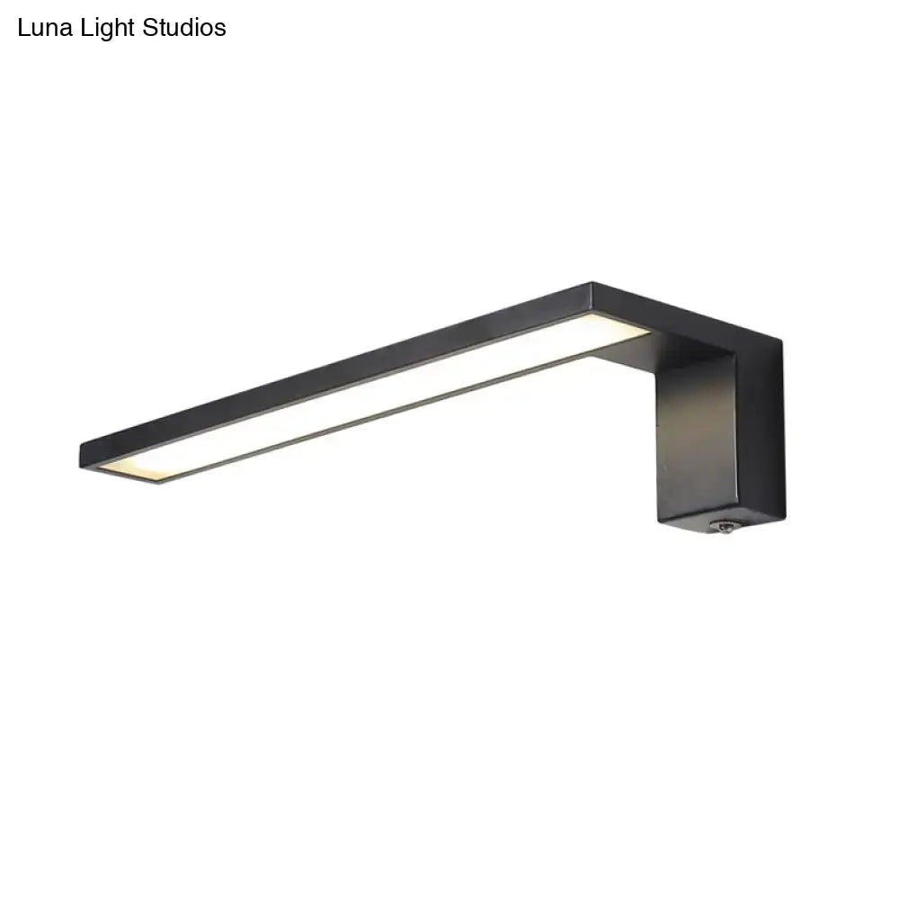 Modern black rectangular wall lamp with sleek minimalist design emitting warm white light for bedroom use
