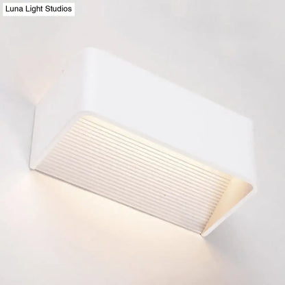 Modern white rectangular wall lamp with ribbed diffuser panel emitting warm white soft illumination for bedroom use