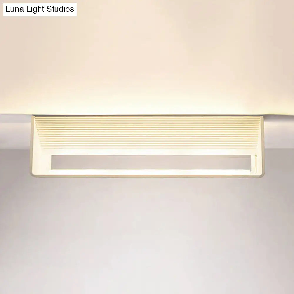 Modern off-white rectangular wall lamp with horizontal slats providing warm white light for bedroom use