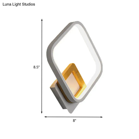 Modern white rhombus wall sconce with sleek gray frame warm gold accent panel and minimalist design for bedroom use
