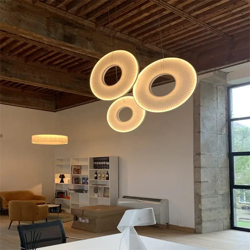 Three glowing modern white ribbed circular pendant lights with woven texture hang from the ceiling decorbites hanging ceiling lamps