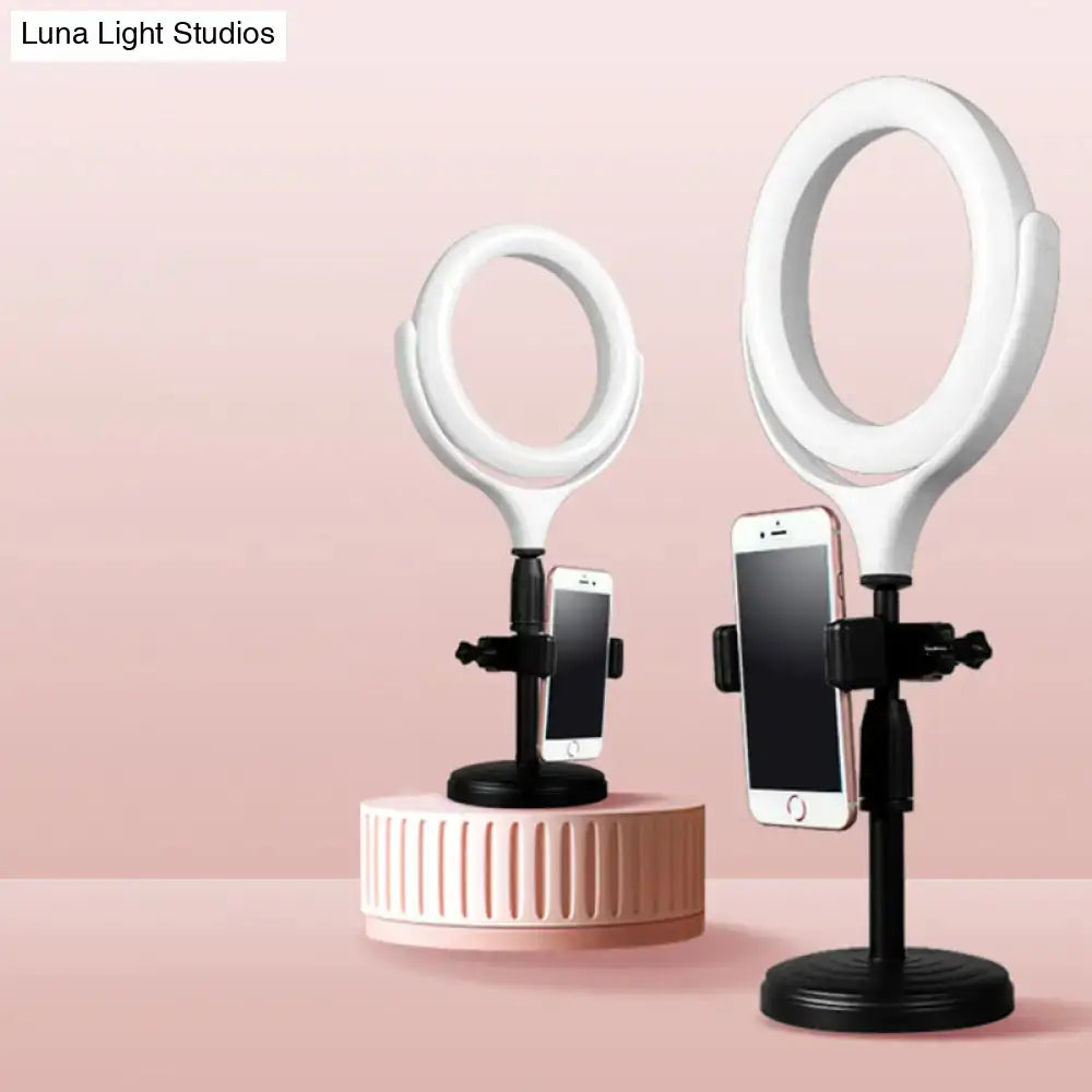 Modern white round mirror light with usb port featuring a white ring mirror light with black stand and phone holder