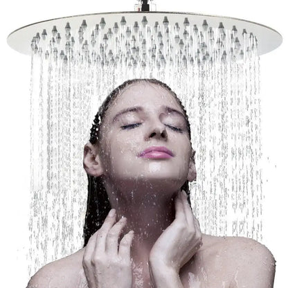A sleek white round rainfall shower head with chrome finish and multiple jets emitting a steady water stream