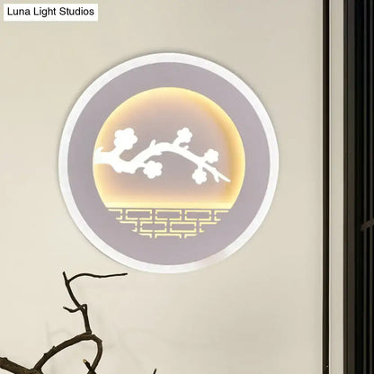 Modern white sailboat tree pattern wall light with circular design and warm amber glow featuring blossoming branches