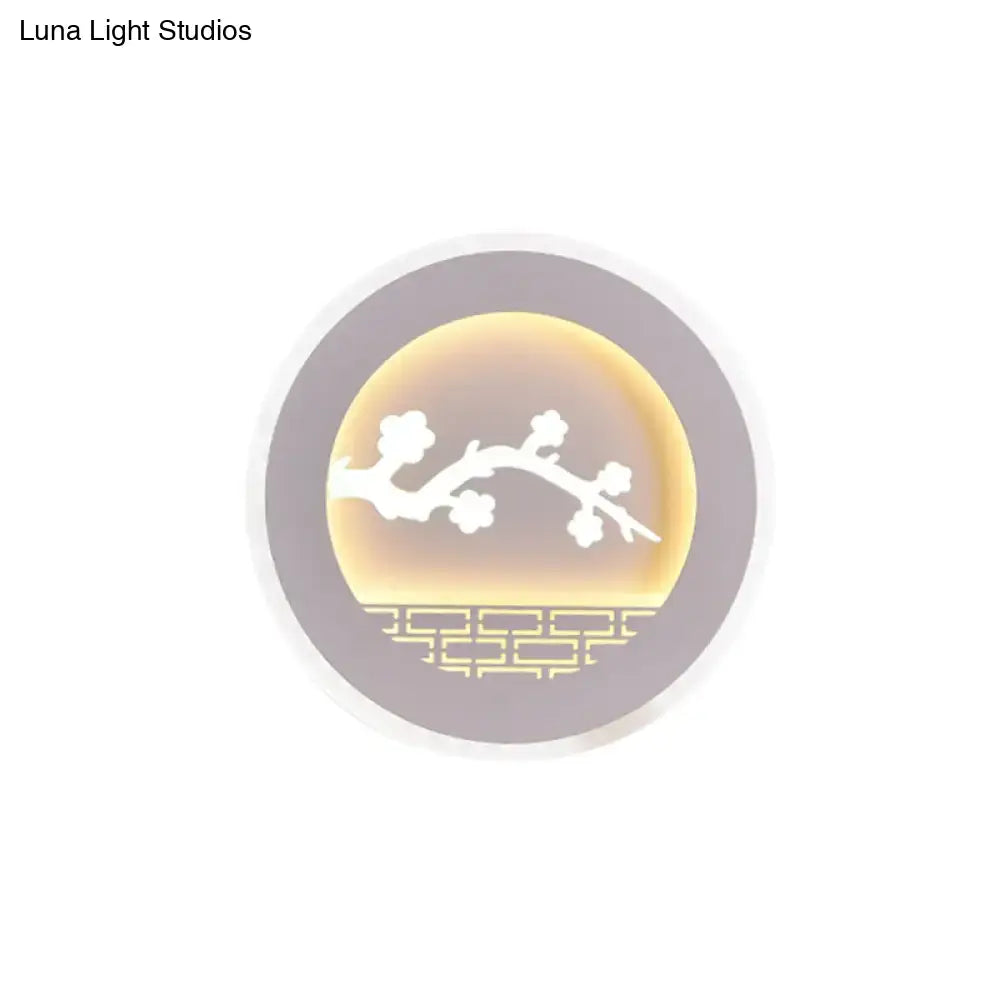 Circular led wall light with warm amber glow featuring white sailboat tree pattern and muted gray frame for bedroom use