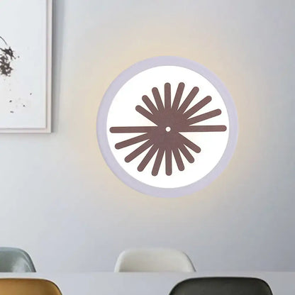 Modern white sector leaf pattern wall light with a white illuminated face and brown radial fan design for living room use