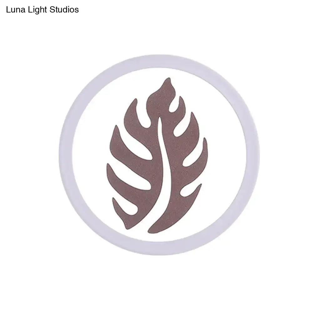 Modern white sector leaf pattern wall light featuring a brown monstera leaf logo encircled by a light gray ring