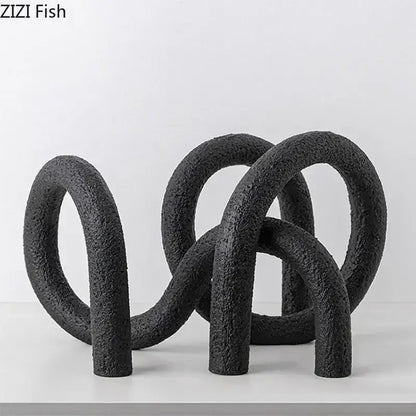 Black textured resin abstract twisted knot sculpture with interlocking circular forms for modern living room decor