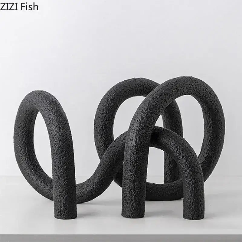 Black textured resin abstract twisted knot sculpture with interlocking circular forms for modern living room decor