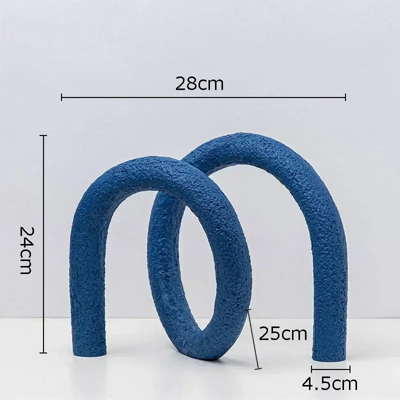 Modern white speckled abstract twisted knot sculpture featuring blue textured interlocking curved arches for living room decor