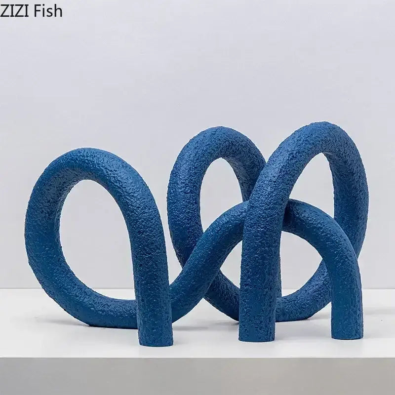 Blue textured abstract twisted knot sculpture with interlocking loops for modern living room decor