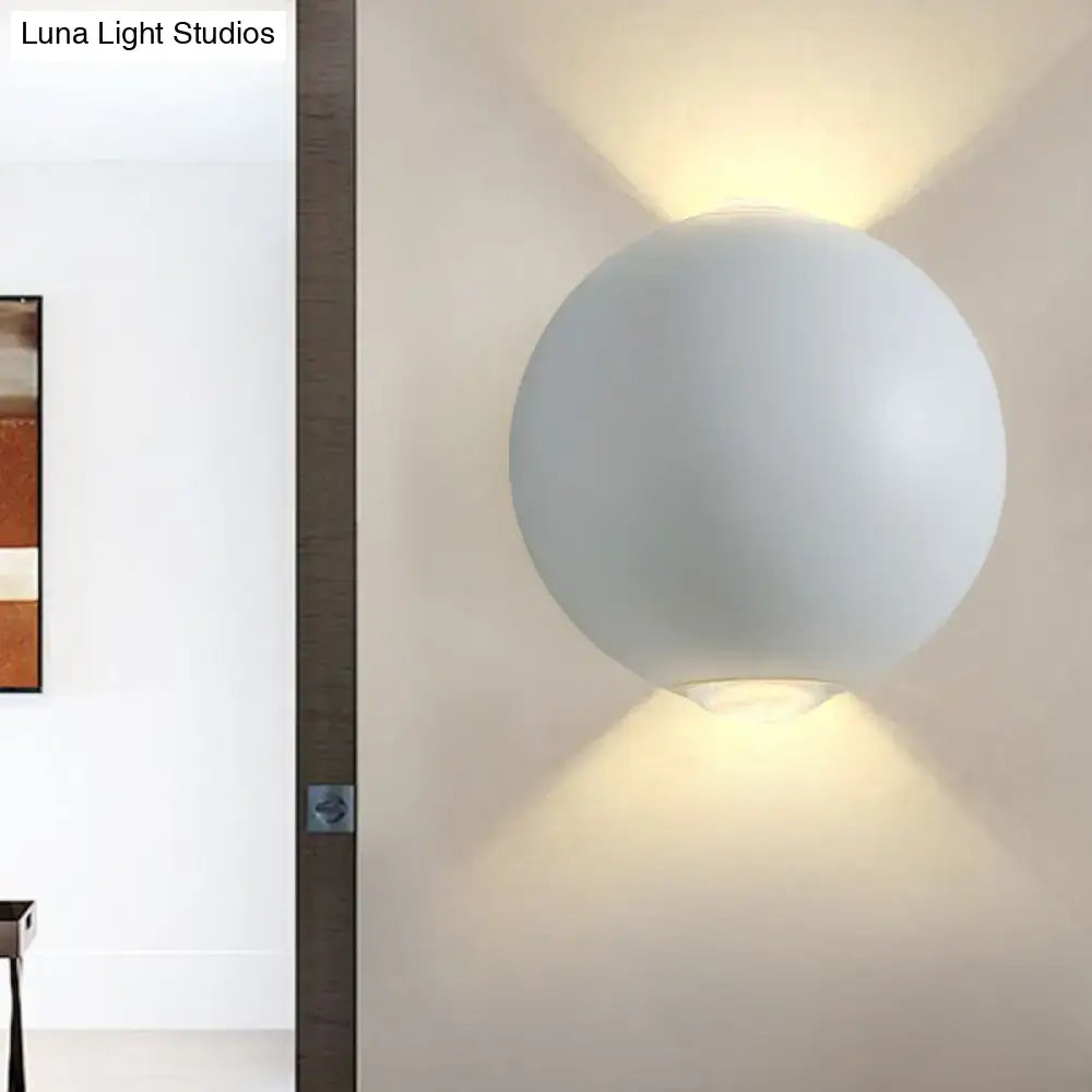 A sleek matte white spherical wall light fixture with minimalist design for modern outdoor wall lighting