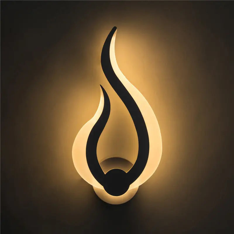 Modern white spiral led wall sconce 8 inch fixture with a sleek black silhouette and warm white flame-shaped light