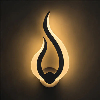 Modern white spiral led wall sconce 8 inch fixture with a sleek black silhouette and warm white flame-shaped light