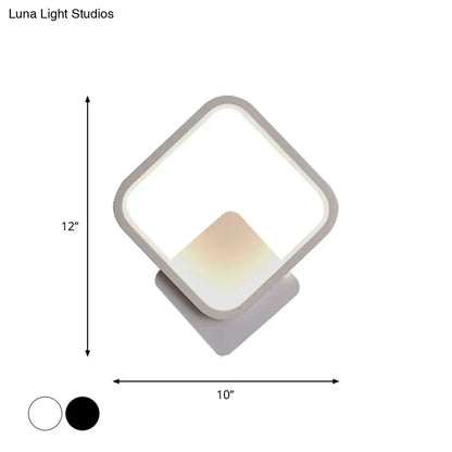 Modern white square bedside wall lamp with sleek frame and soft glowing light available in black and white finishes