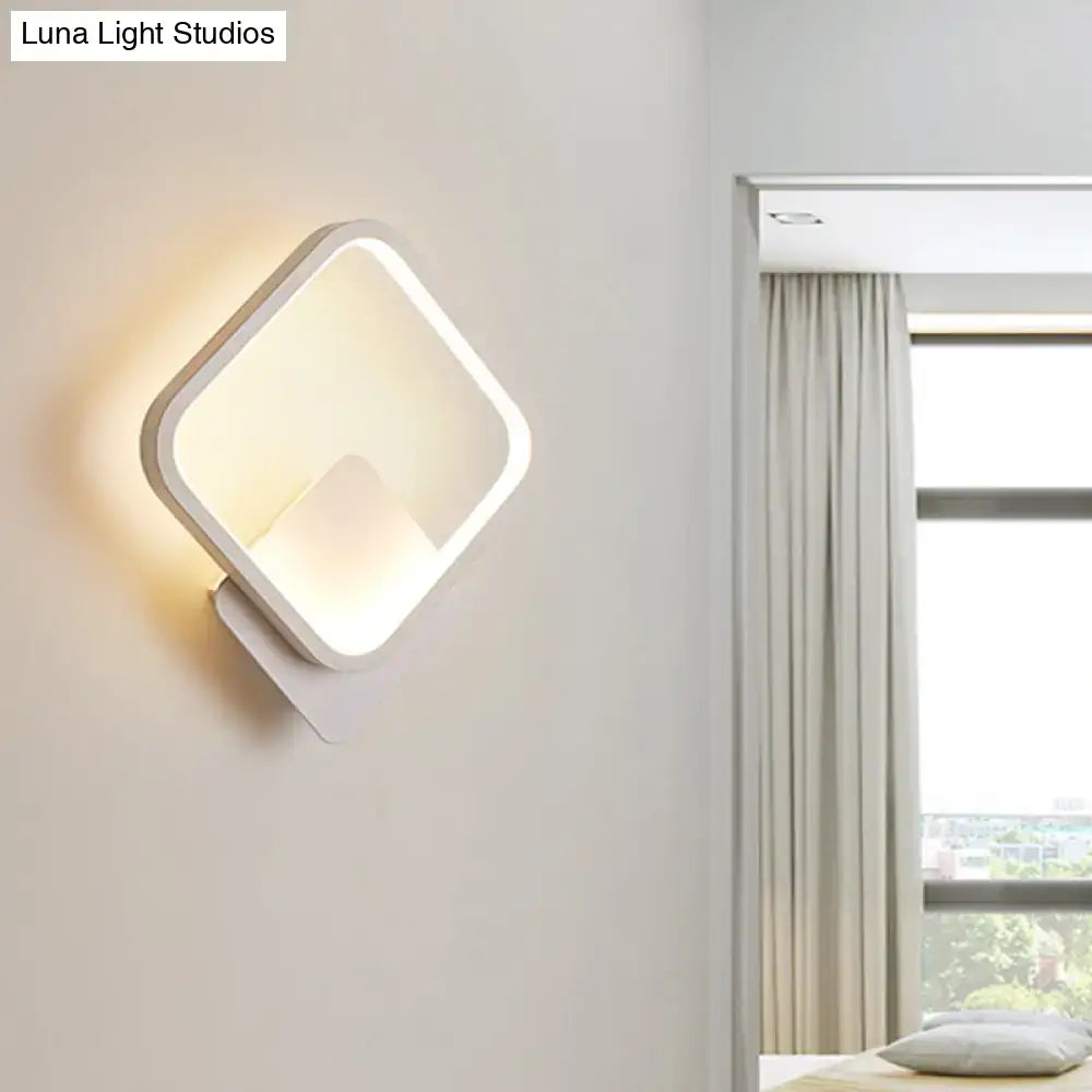 Modern white square bedside wall lamp with minimalist design providing soft warm glow for bedroom lighting