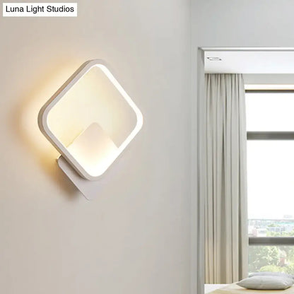 Modern white square bedside wall lamp with minimalist design providing soft warm glow for bedroom lighting