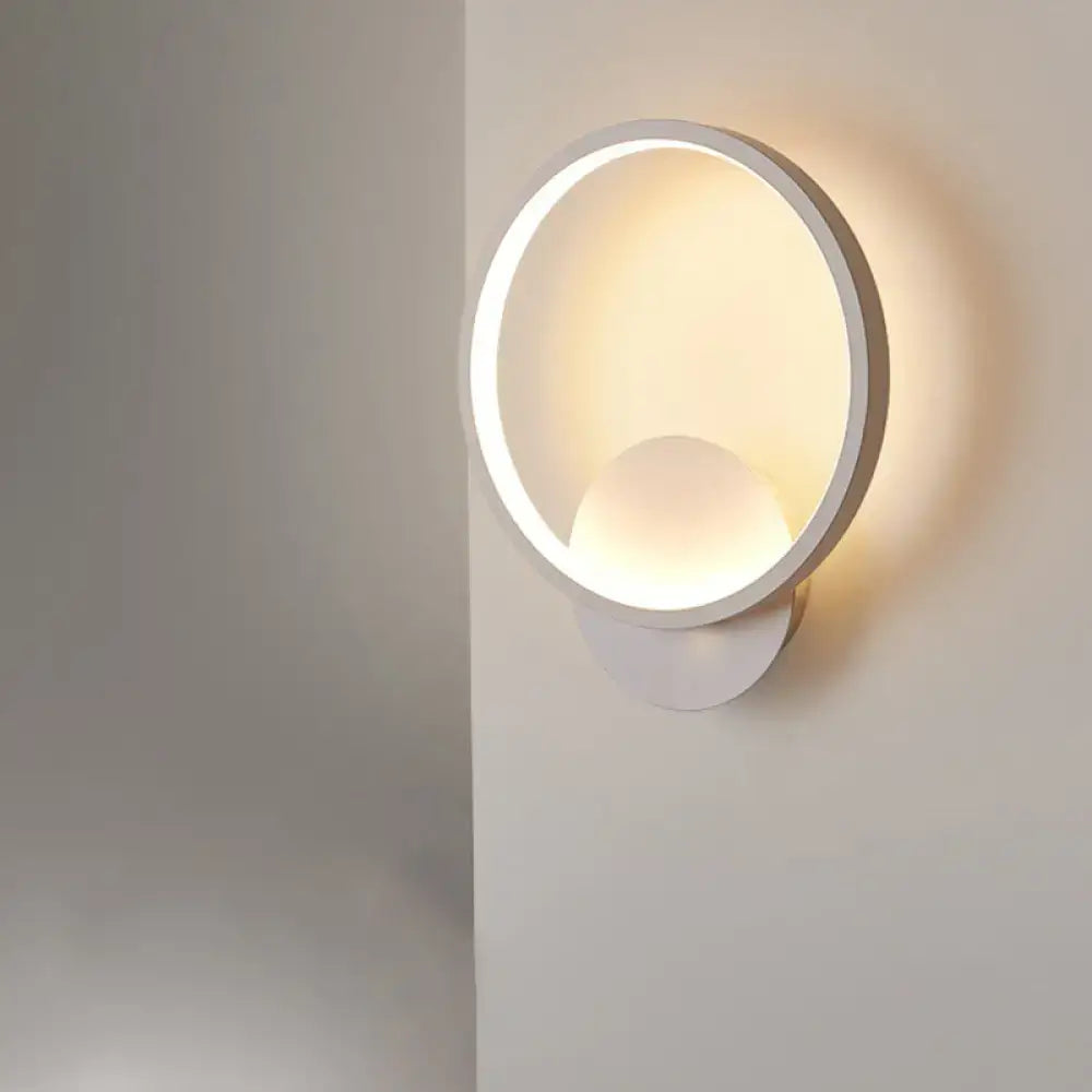 Modern white black white bedside wall lamp with circular glowing ring and spherical light for minimalist bedroom lighting