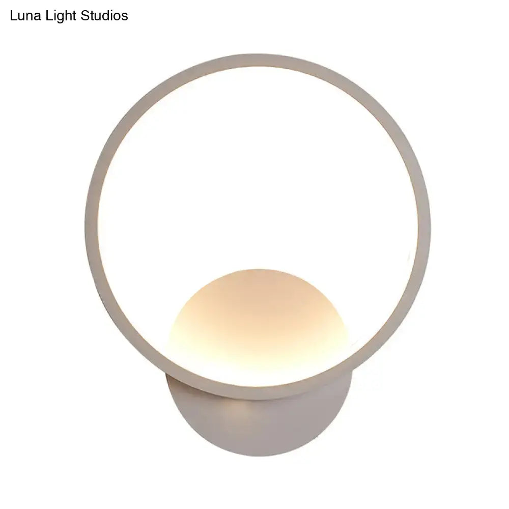 Modern white square bedside wall lamp with a black white minimalist circular frame and warm spherical light