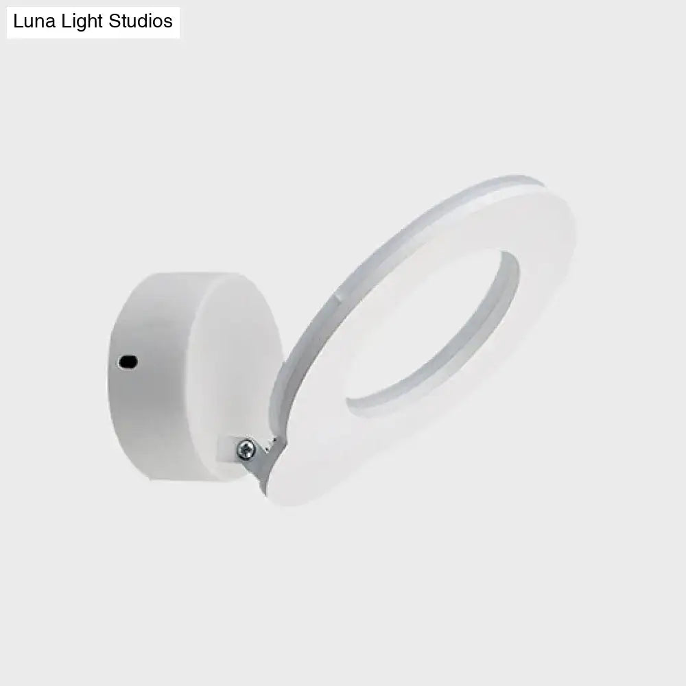 Modern white circular wall sconce with warm natural color temperature and minimalist design for bedroom lighting