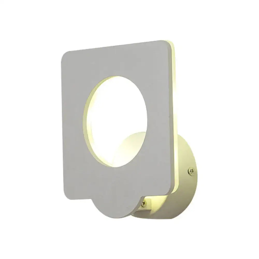 Modern white square led wall sconce with circular cutout emitting warm natural light and adjustable color temperature for bedrooms