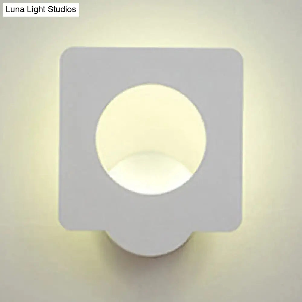 Modern white square led wall sconce with matte finish and circular cutout emitting warm natural light with color temperature