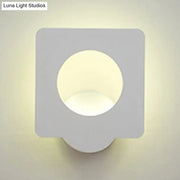 Modern white square led wall sconce with matte finish and circular cutout emitting warm natural light with color temperature