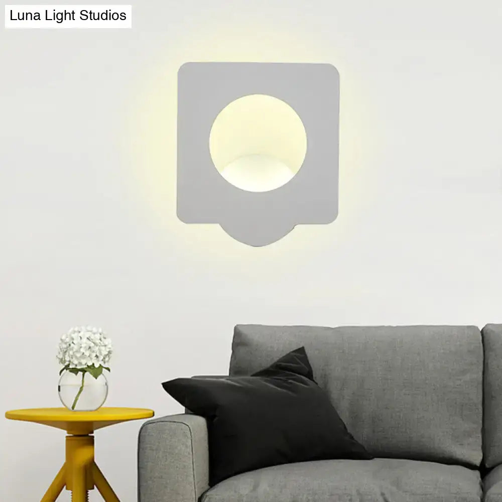 Modern gray wall sconce with circular light fixture providing warm natural color temperature for bedroom use