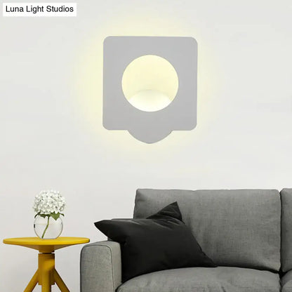 Modern gray wall sconce with circular light fixture providing warm natural color temperature for bedroom use