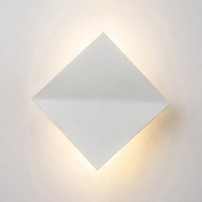 Modern white diamond wall sconce with direct wired electric installation emitting soft warm light for living space