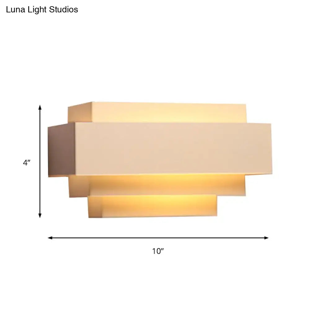 Modern beige rectangular wall sconce with layered design and warm ambient lighting ideal as a bedroom wall lamp