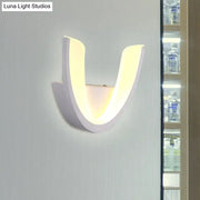 Modern white u-shaped led wall sconce with sleek curved design and warm white light for bedroom illumination