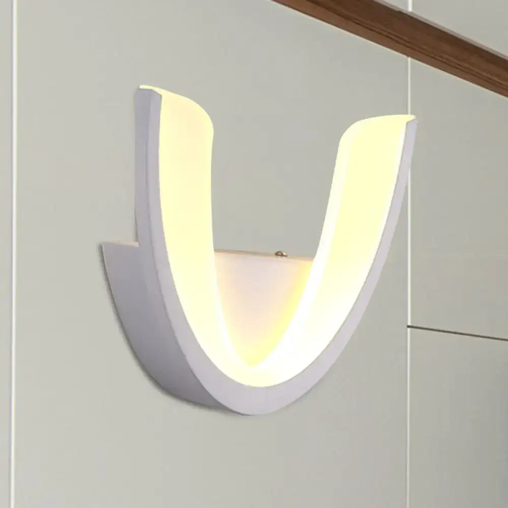 Modern white u-shaped led wall sconce with a soft warm glow ideal for bedroom lighting and ambiance