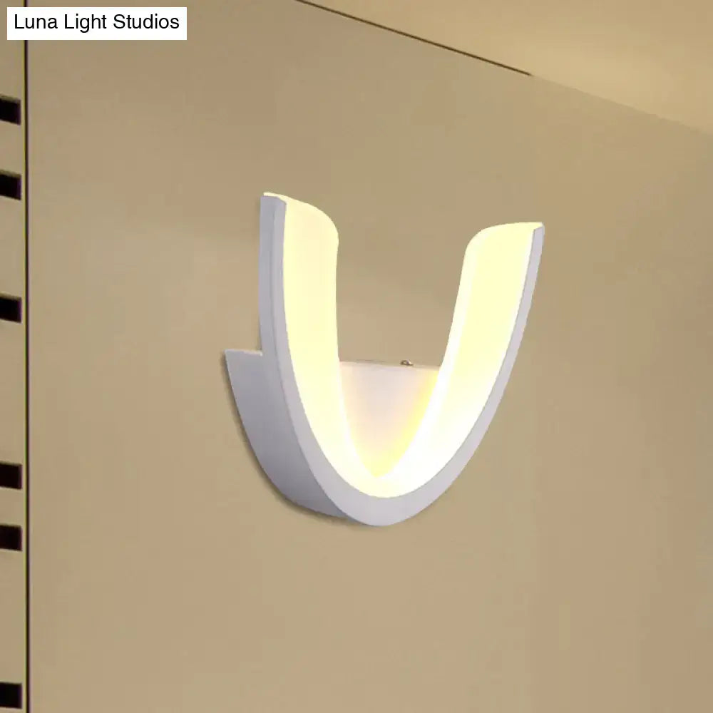 Modern white u-shaped led wall sconce with minimalist design providing warm and white ambient bedroom lighting