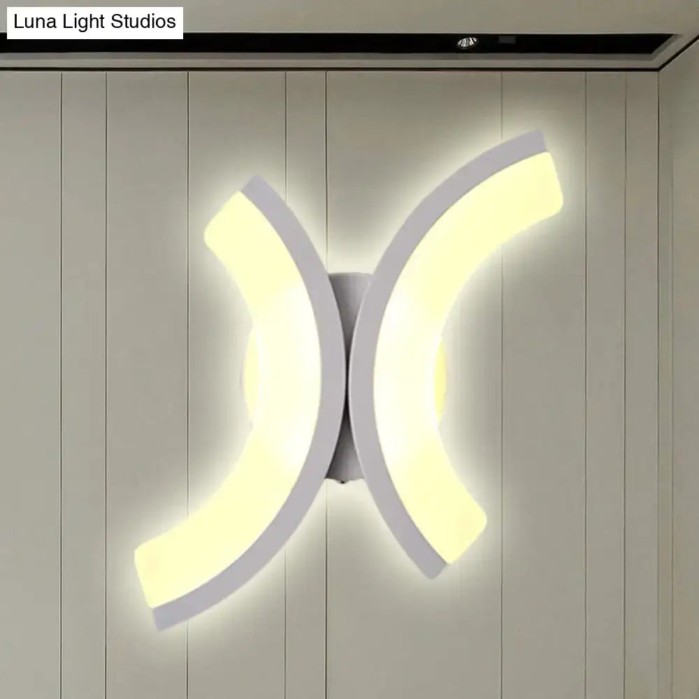 Modern white u-shaped led wall sconce with sleek curved arms emitting warm and white bedroom light