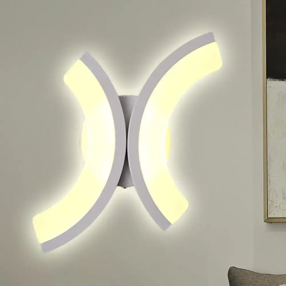 Modern white u-shaped led wall sconce with two curved illuminated arms forming an x-shape for bedroom lighting
