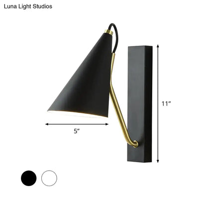 Black conical wall lamp with brass accent arm and mounting plate in black finish for modern bedroom lighting